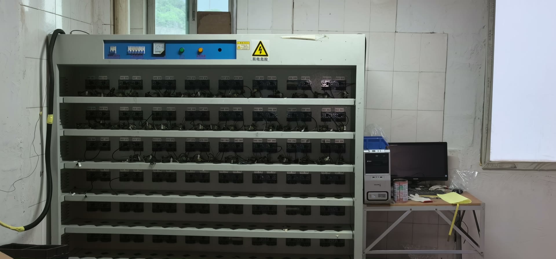 Burn-in aging cabinet loaded with adapters